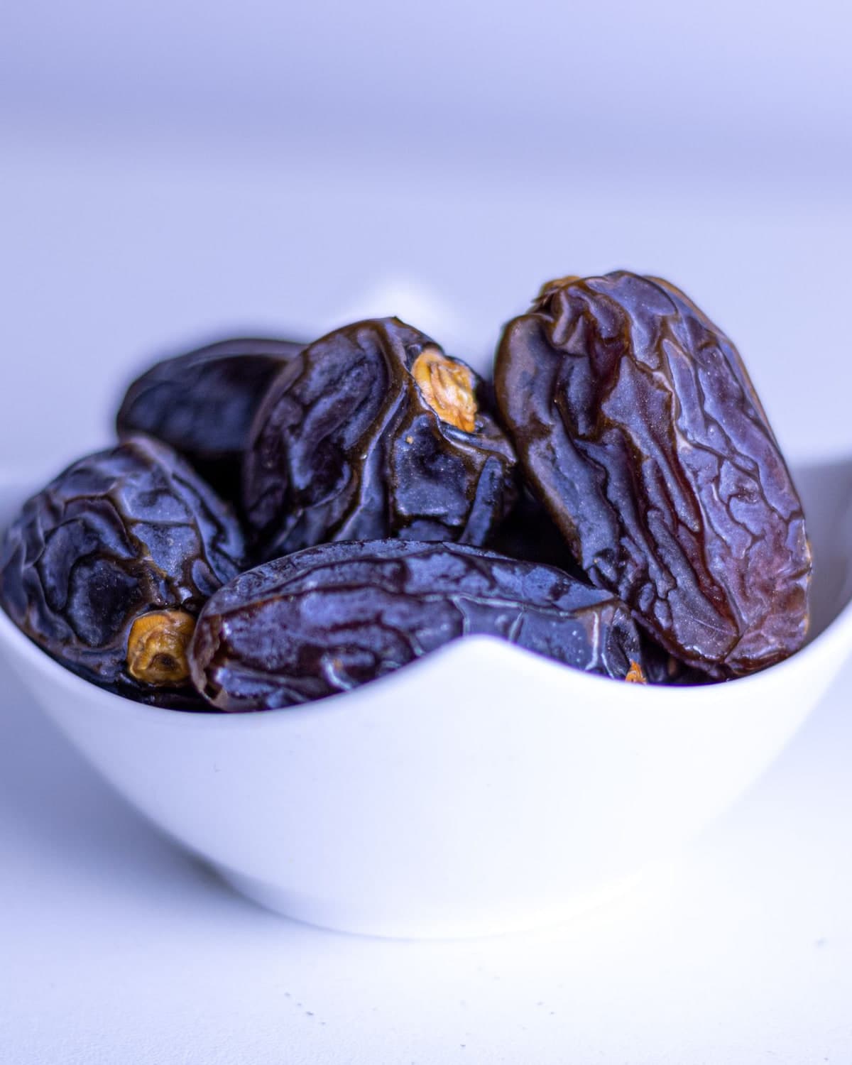 Dark BM Ajwa dates in a white bowl