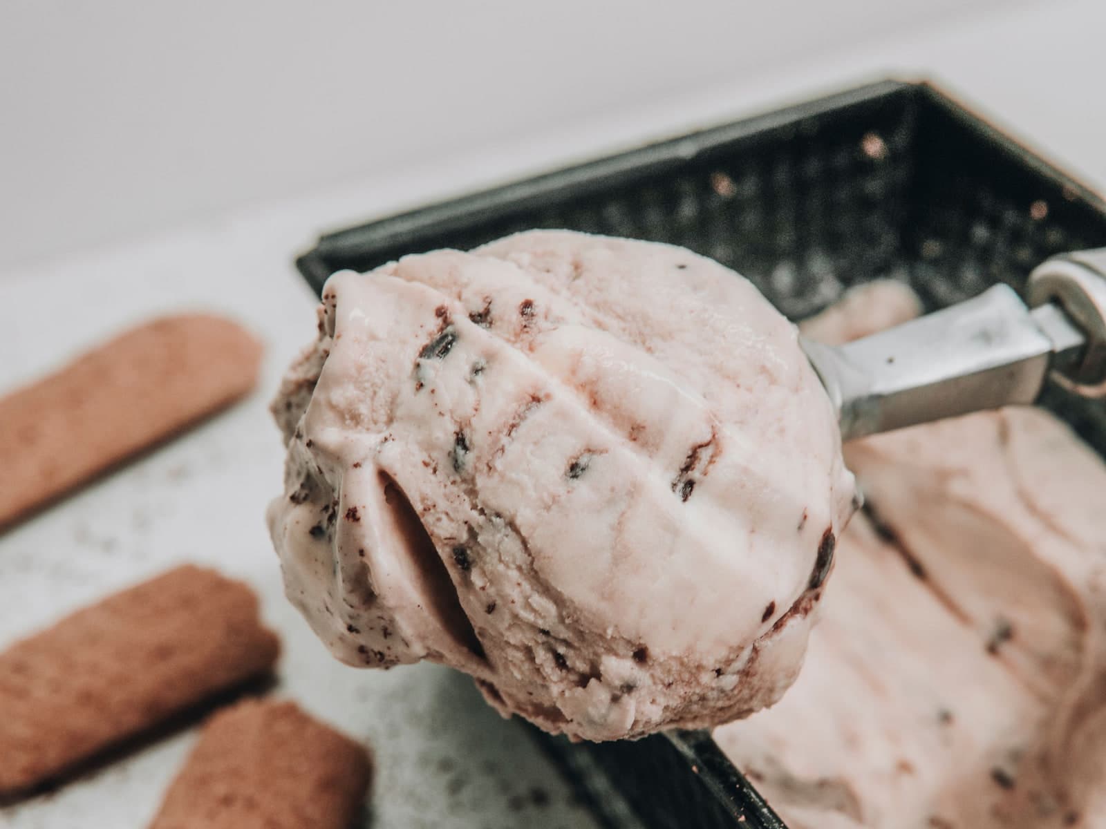 A scoop of ice cream lifted from the tray