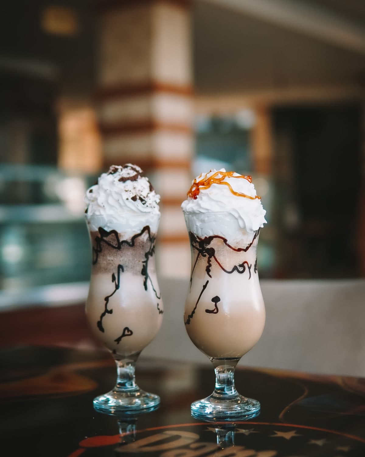 Two thick shakes topped with cream